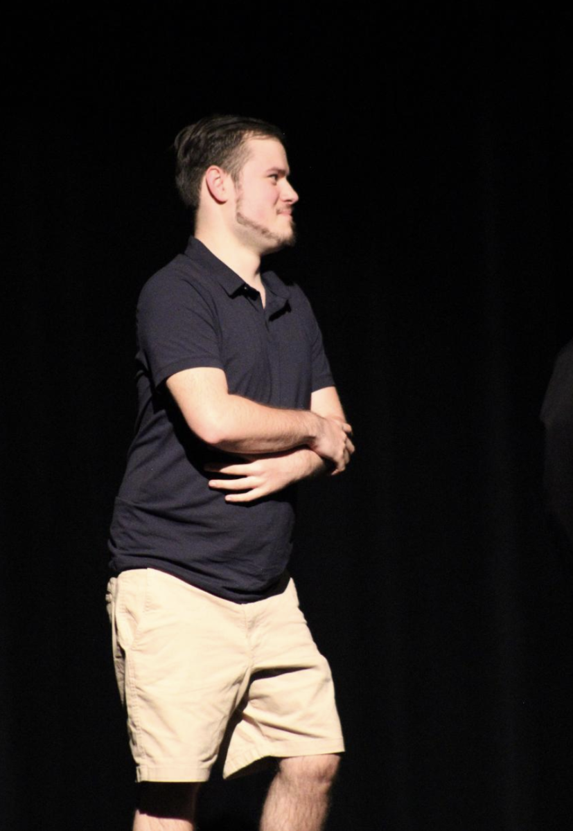 Cole Vianello listens on stage to recognition comments by Ms. Larson for his outstanding work as a yearbook staffer.
